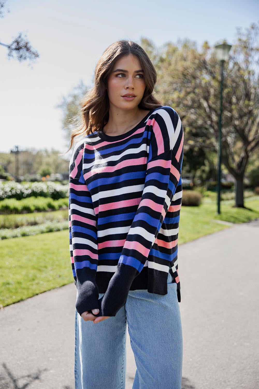 A model wearing the Logan Stripe Knit in colour Navy (Blue), from the front, showing the whole outfit