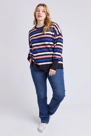 A model wearing the Logan Stripe Knit in colour Navy (Blue), from the front, showing the whole outfit
