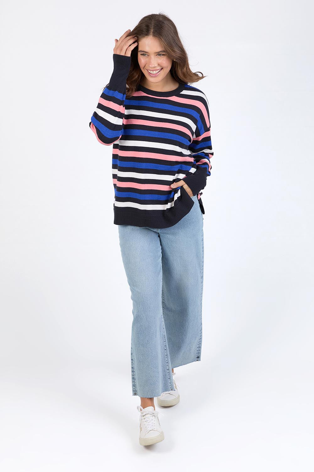 A model wearing the Logan Stripe Knit in colour Navy (Blue), from the front, showing the whole outfit