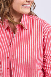 A model wearing the Frankie Striped Cotton Shirt in colour Cayenestri (Red), from the front, cropped image