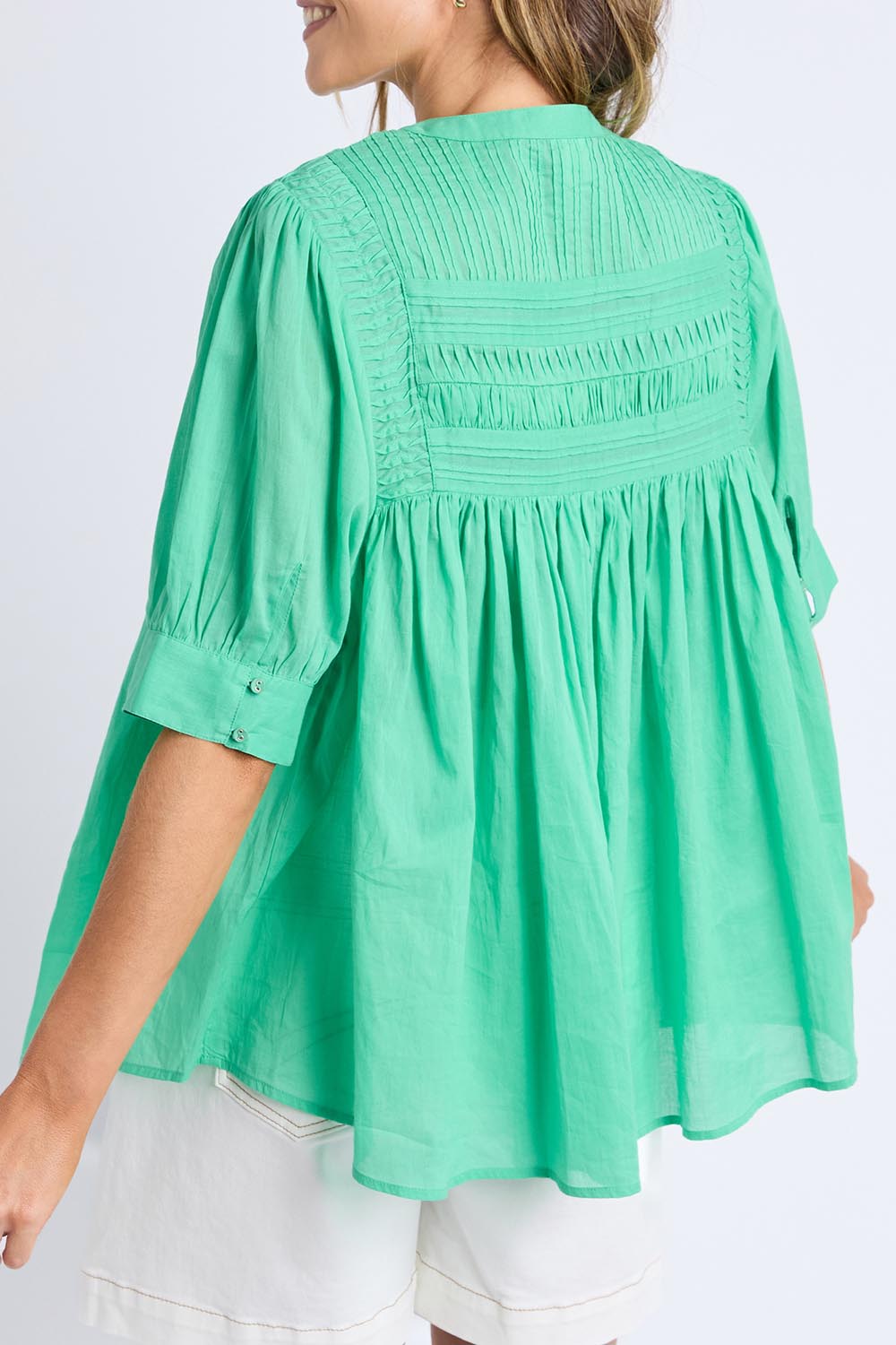 A model wearing the Monty Cotton Short Sleeve Shirt in colour Gumdrop (Green), from the back