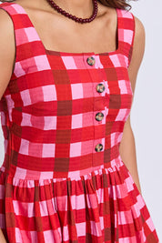 A model wearing the Edin Cotton Dress in colour Poppycheck, from the front, cropped image
