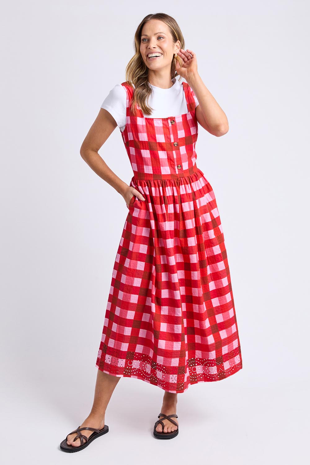 A model wearing the Edin Cotton Dress in colour Poppycheck, from the front, showing the whole outfit