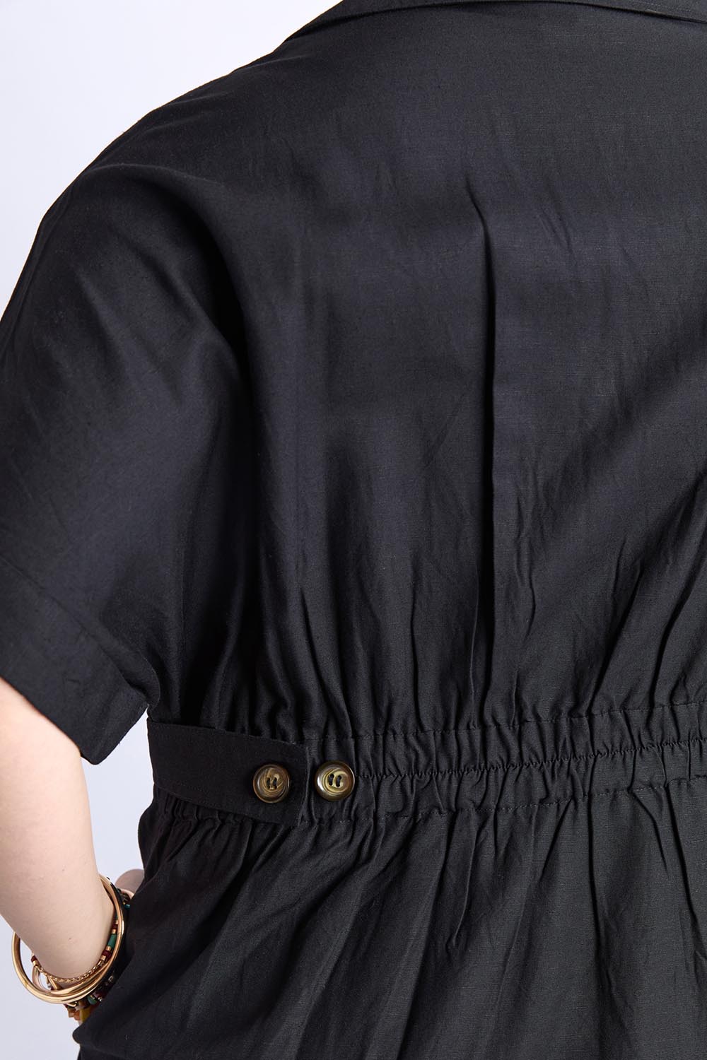 A model wearing the Hillary Linen Blend Dress in colour Black (Black), from the front, cropped image