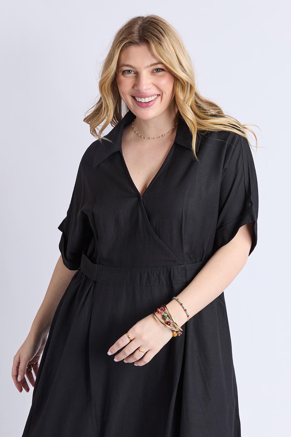 A model wearing the Hillary Linen Blend Dress in colour Black (Black), from the front, cropped image