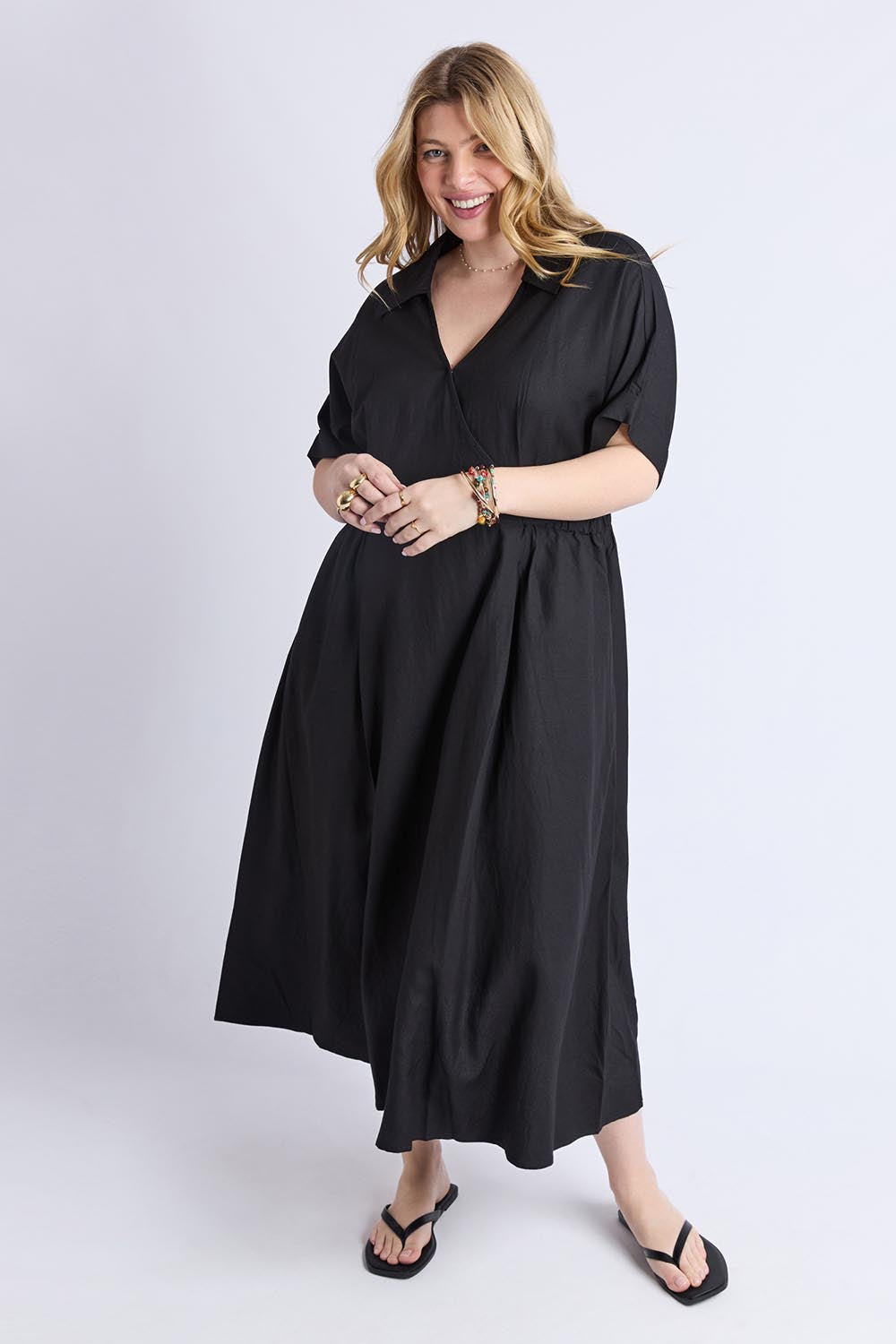 A model wearing the Hillary Linen Blend Dress in colour Black (Black), from the front, showing the whole outfit