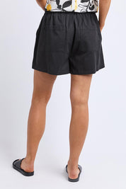 A model wearing the Lucinda Lyocell Cotton Short in colour Black (Black), from the back