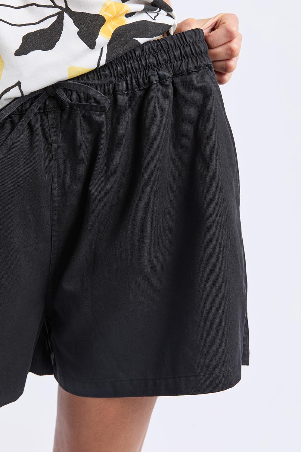 A model wearing the Lucinda Lyocell Cotton Short in colour Black (Black), from the front, cropped image