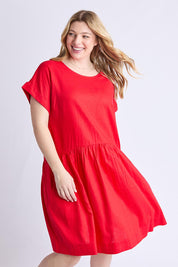A model wearing the Sunset Hour Linen Blend Dress in colour Poppy (Red), from the front, cropped image