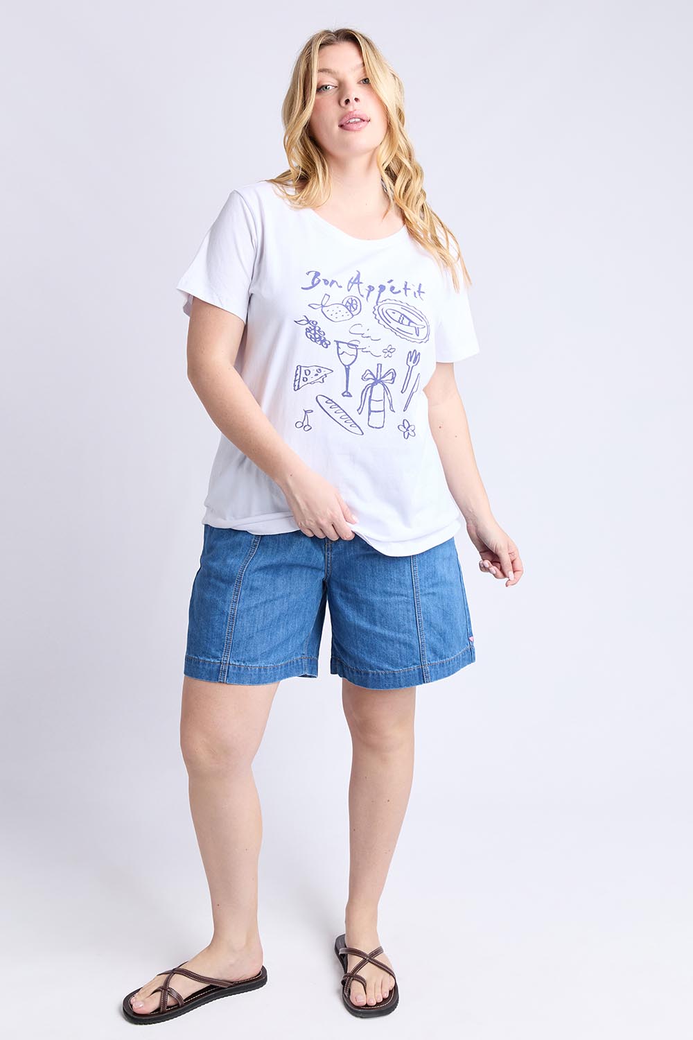 A model wearing the Bon Appetit Cotton Tee in colour White (White), from the front, showing the whole outfit