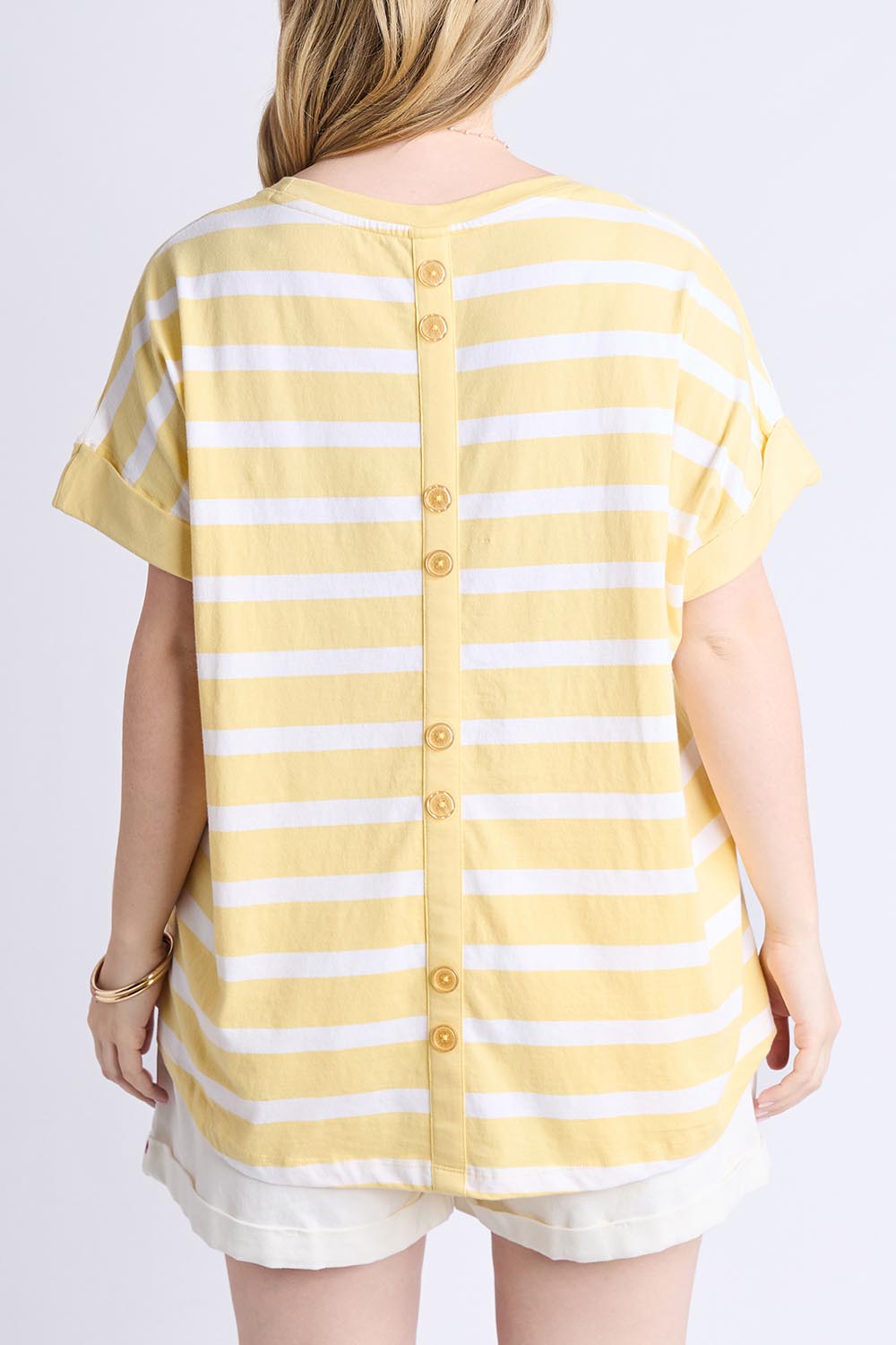A model wearing the Maddison Cotton Tee in colour Banana, from the back