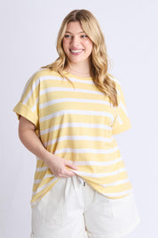 A model wearing the Maddison Cotton Tee in colour Banana, from the front, cropped image