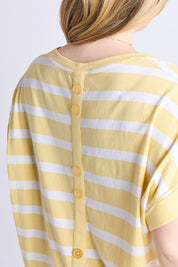 A model wearing the Maddison Cotton Tee in colour Banana, from the front, cropped image