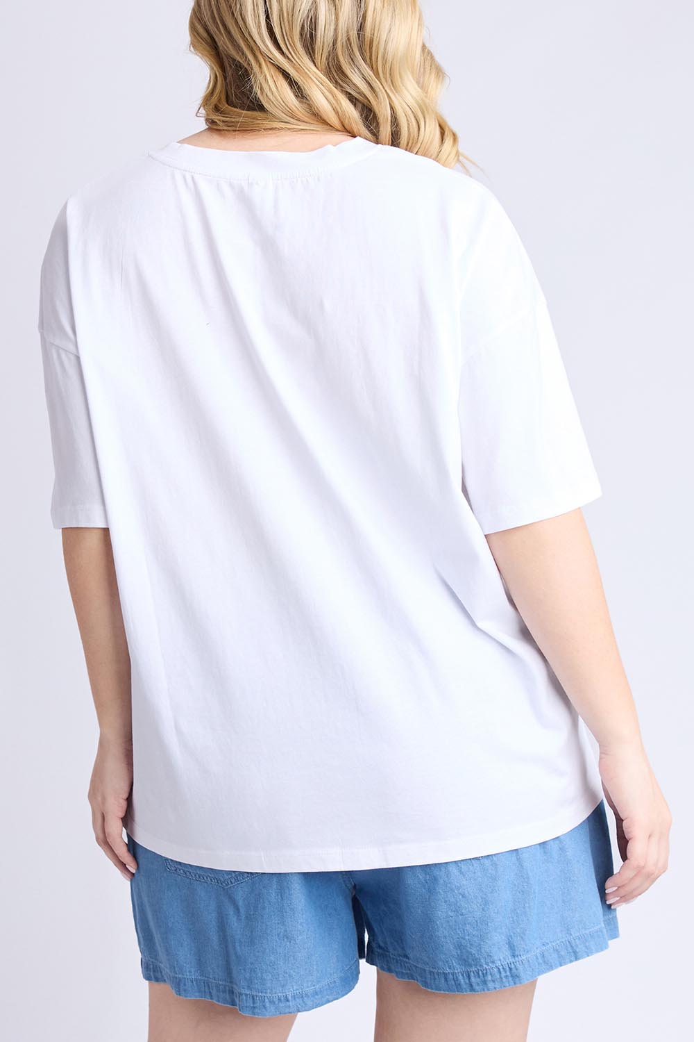 A model wearing the Limone Fresco Cotton Tee in colour White (White), from the front, cropped image
