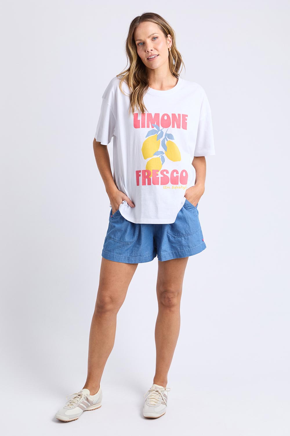 A model wearing the Limone Fresco Cotton Tee in colour White (White), from the front, showing the whole outfit