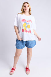 A model wearing the Limone Fresco Cotton Tee in colour White (White), from the front, showing the whole outfit