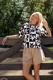 A model wearing the Splice Cotton Tee in colour Blackwhite, from the front, showing the whole outfit