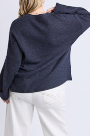 A model wearing the Intersia Heart Knit in colour Navy (Blue), from the back