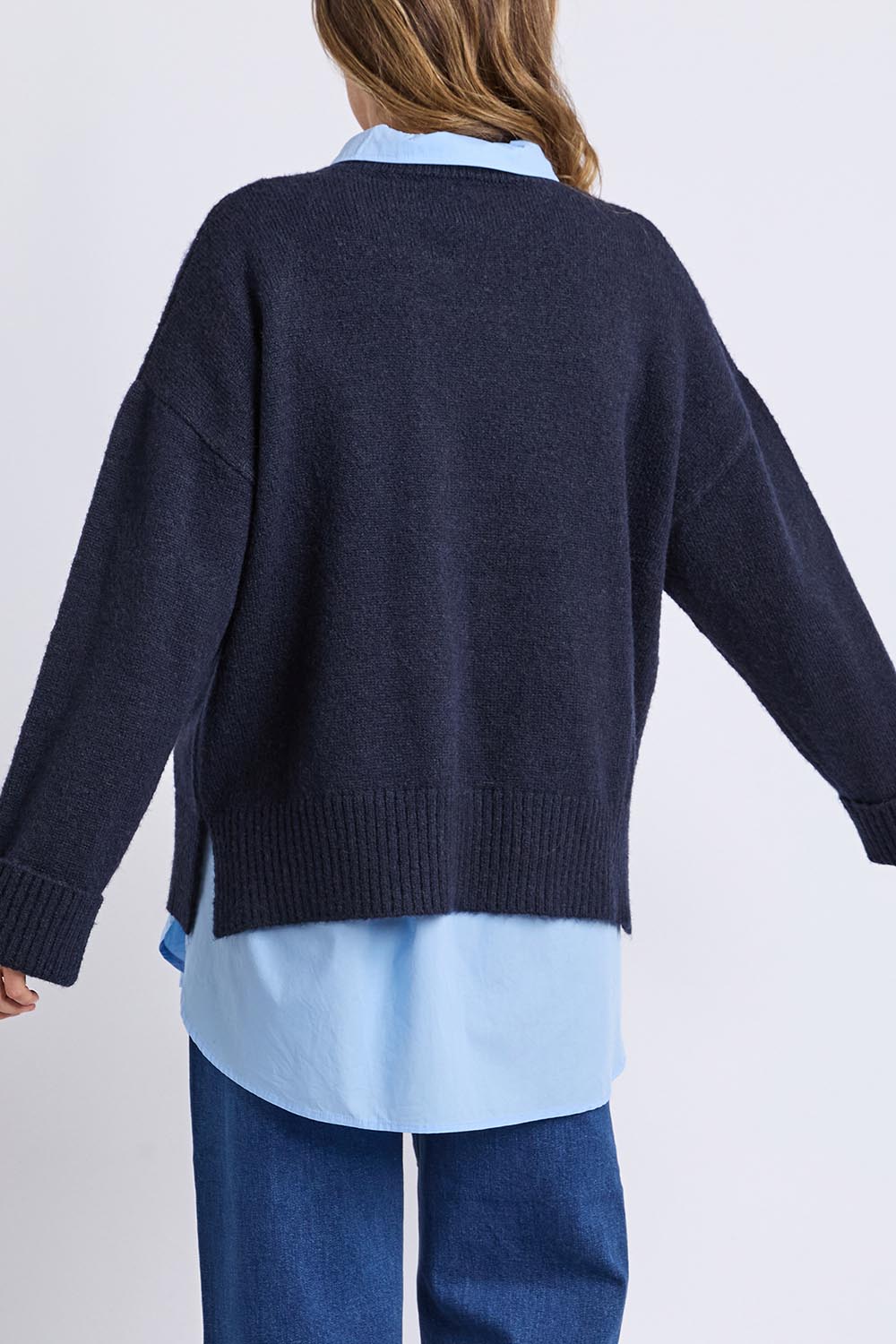 A model wearing the Lobster Intersaid Knit in colour Navy (Blue), from the back