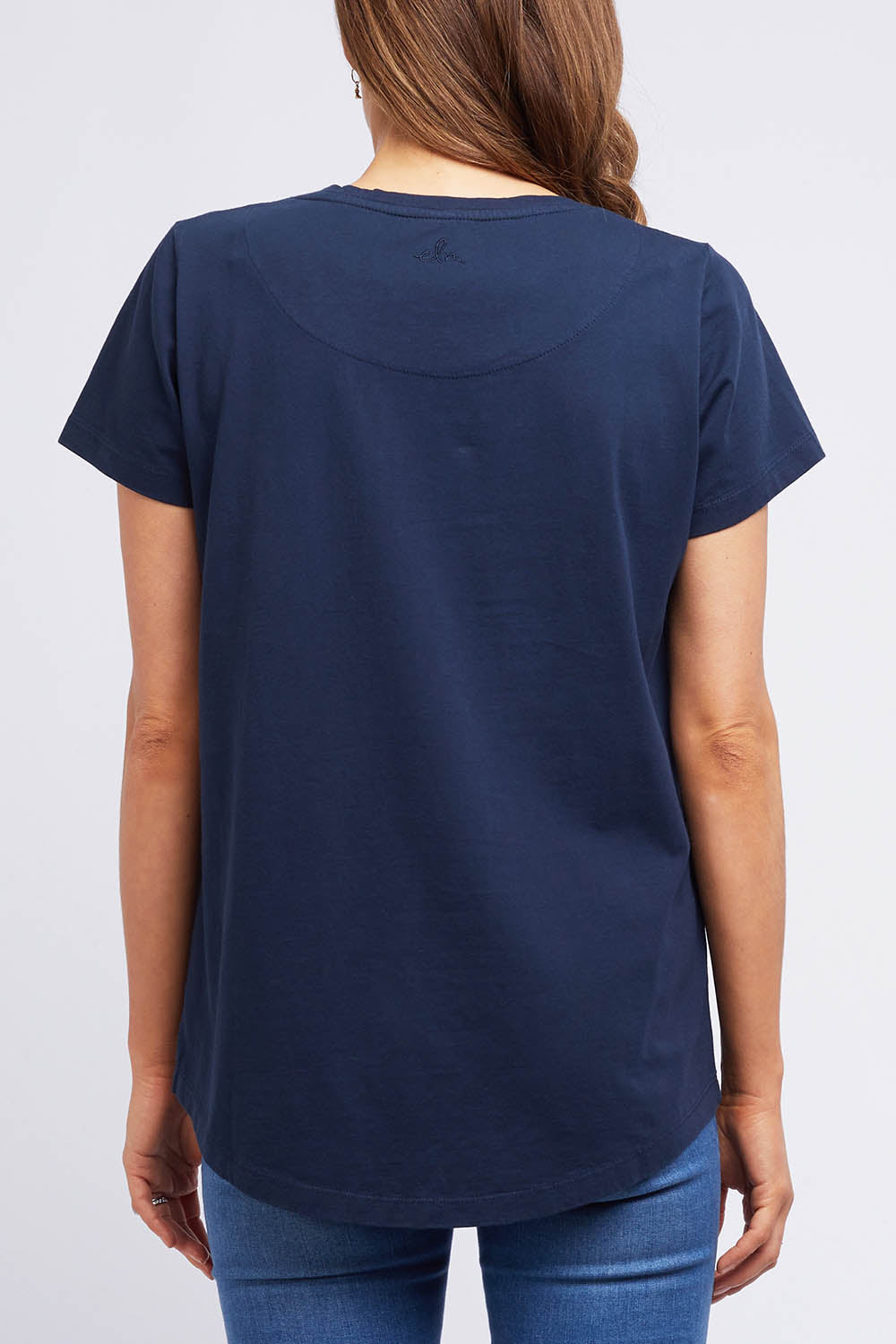 A model wearing the Crescent SS Tee in colour Navy (Green), from the back