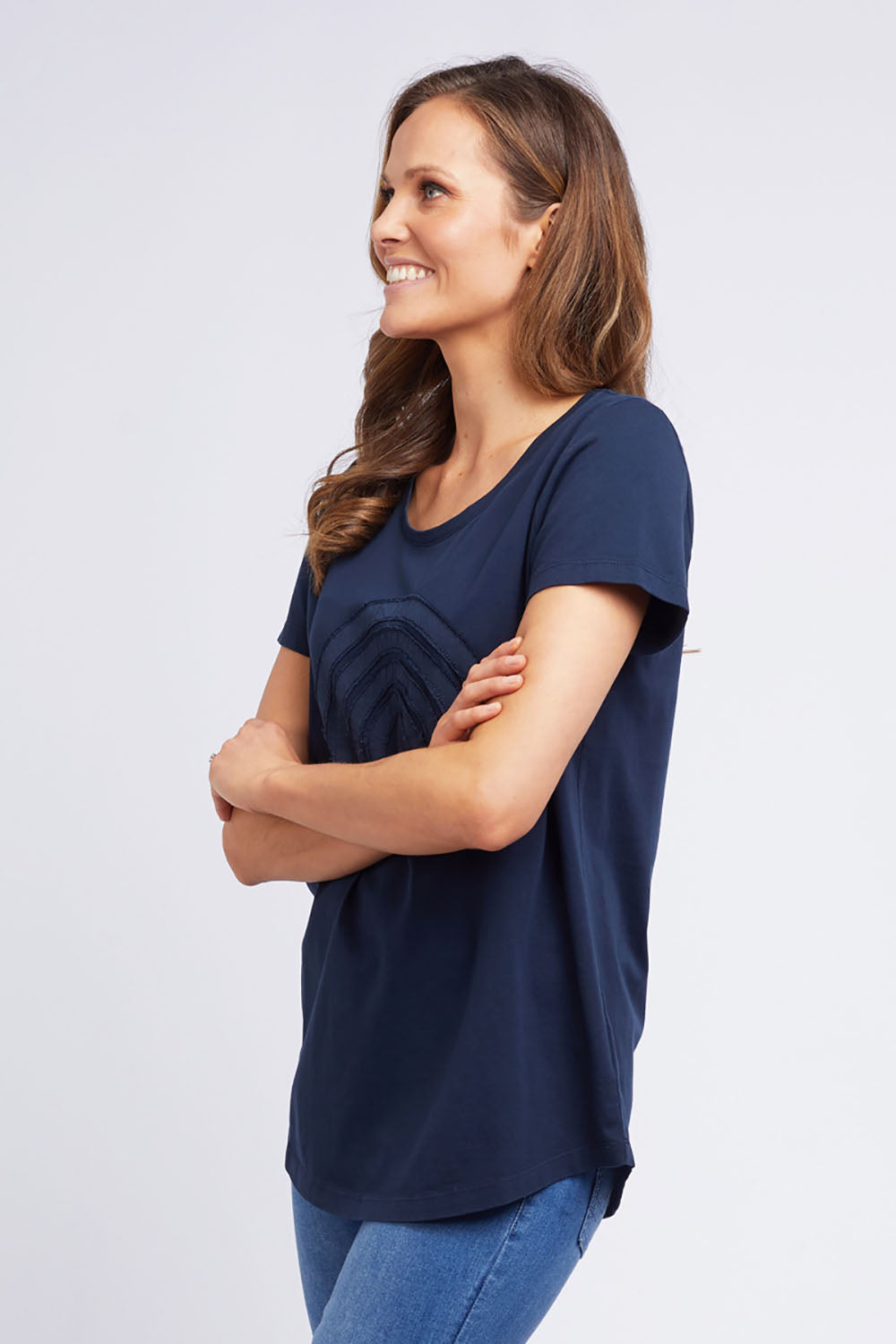 A model wearing the Crescent SS Tee in colour Navy (Green), from the front, cropped image
