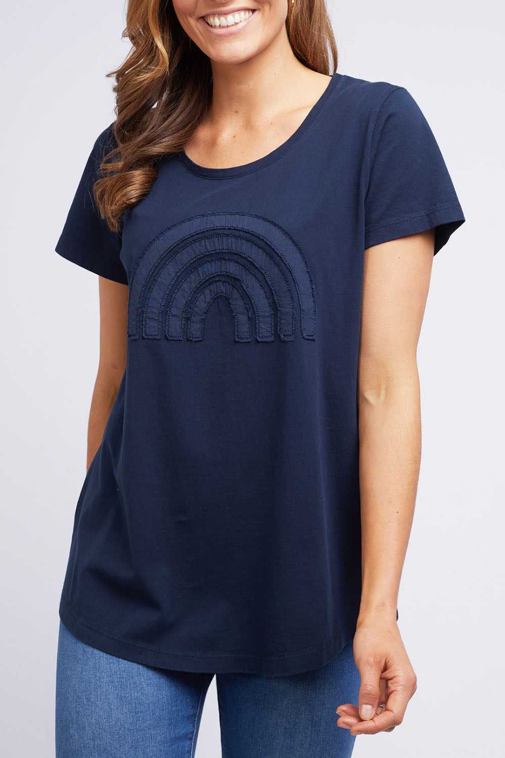 A model wearing the Crescent SS Tee in colour Navy (Green), from the front, cropped image