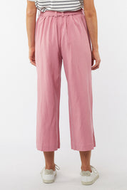 A model wearing the Dylan Wide Leg Pant in colour Rose (Pink), from the back