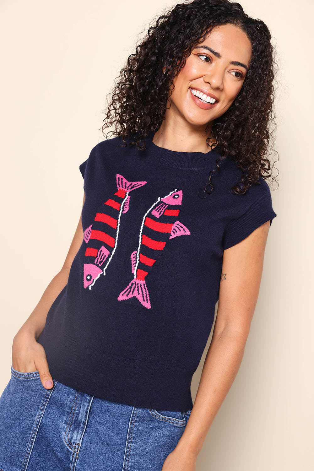 Model Pamelar wearing size 10 of the Fishy Intersia Vest – Chinablue in colour Chinablue, from an angle
