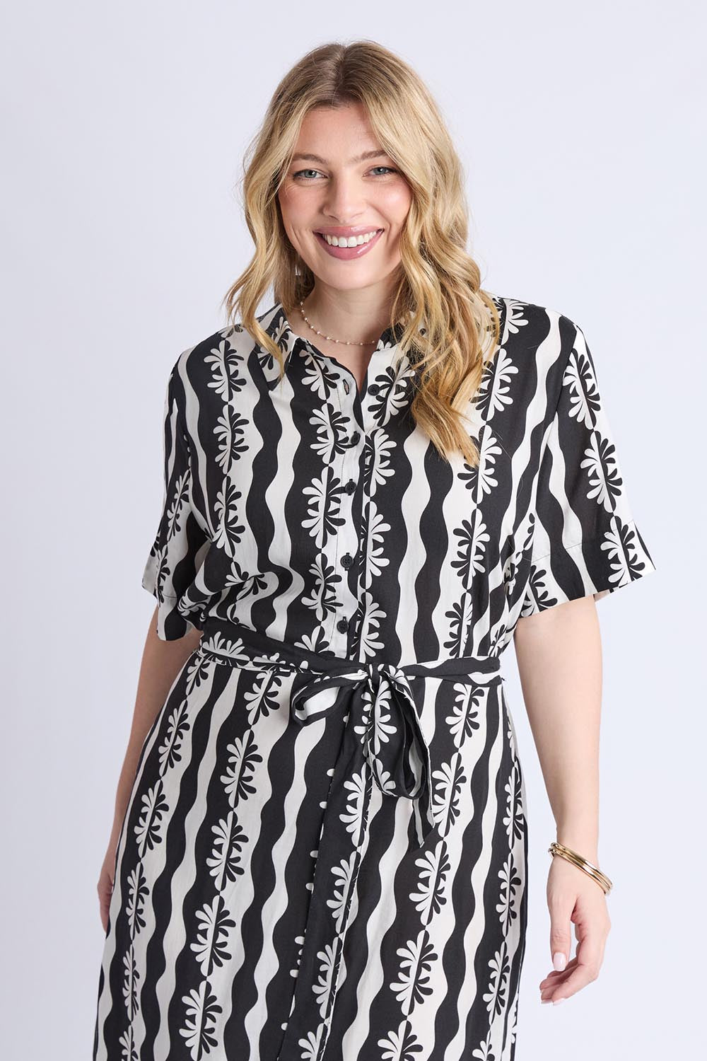 A model wearing the Casa Dress in colour Blackmarsh (Black), from the front, cropped image
