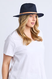 A model wearing the Palm Hat in colour Navy (Blue), from the front, cropped image