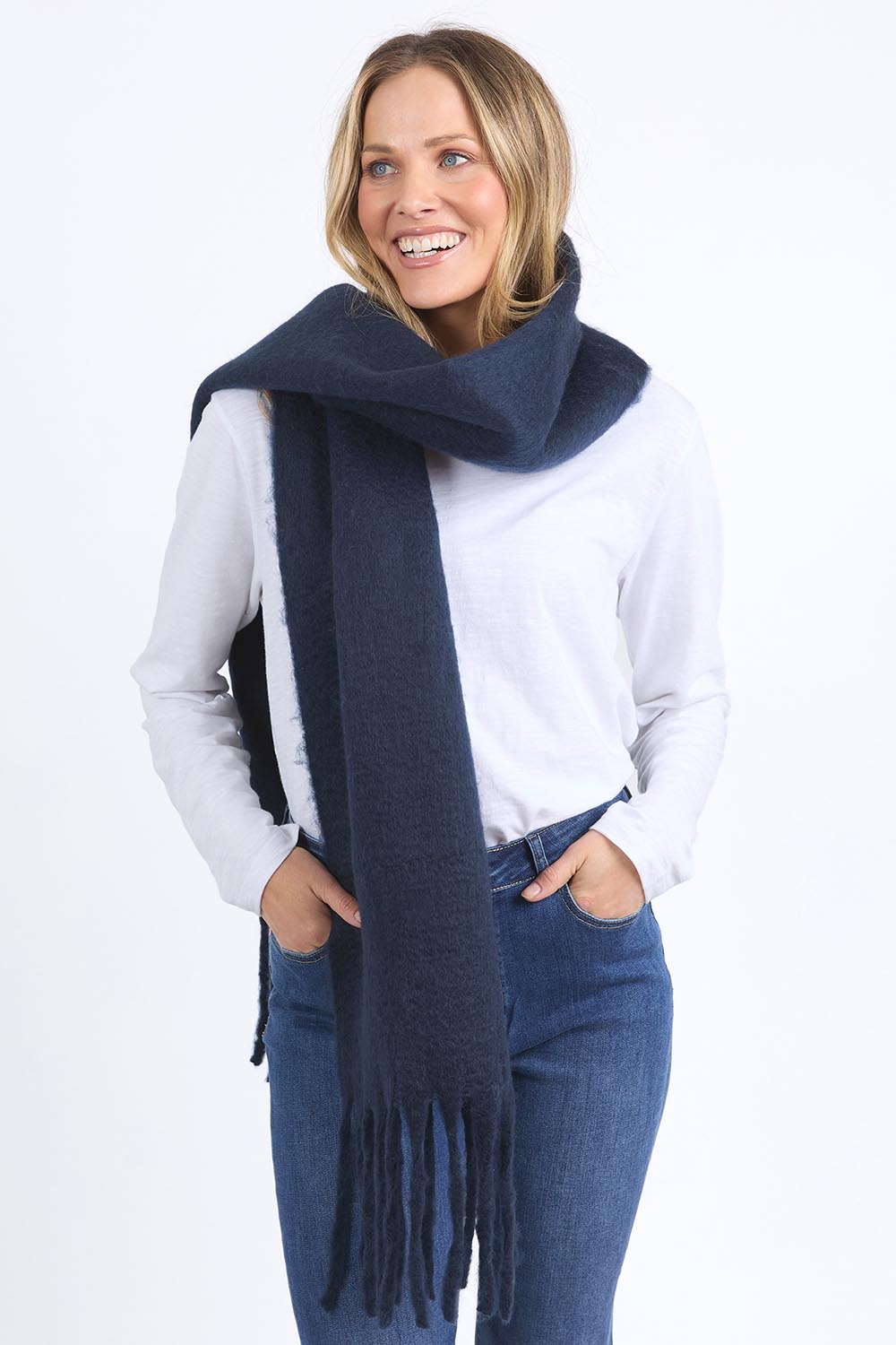 A model wearing the Cosy Scarf in colour Navy (Blue), from the front, cropped image