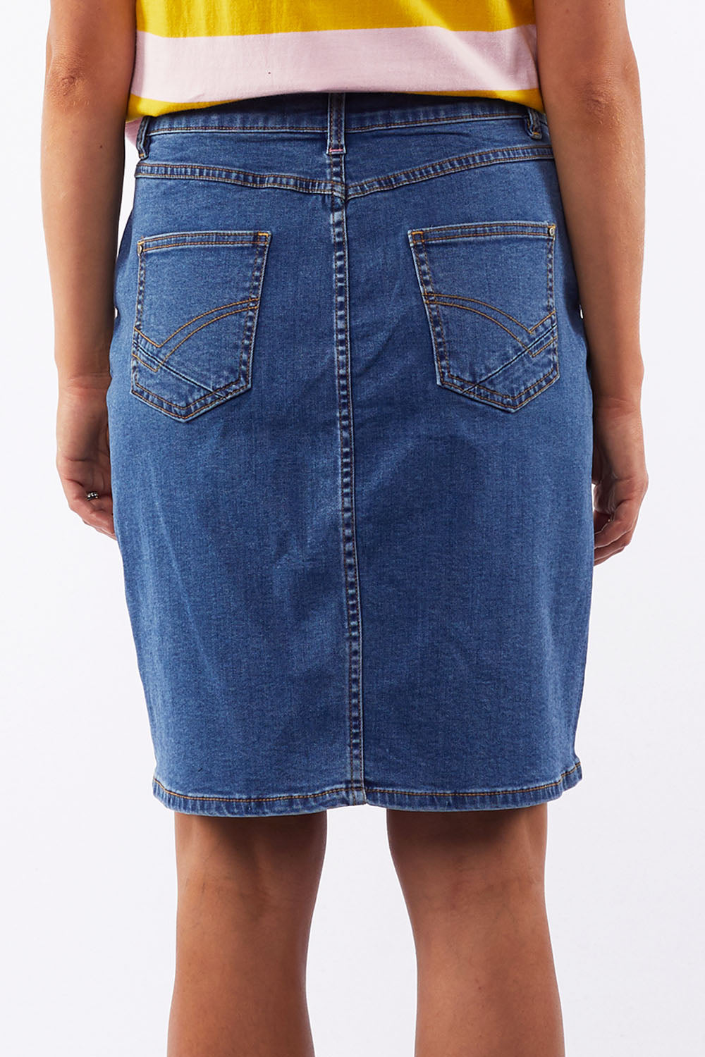 A model wearing the Chloe Denim Skirt in colour Midblue (Blue), from the back