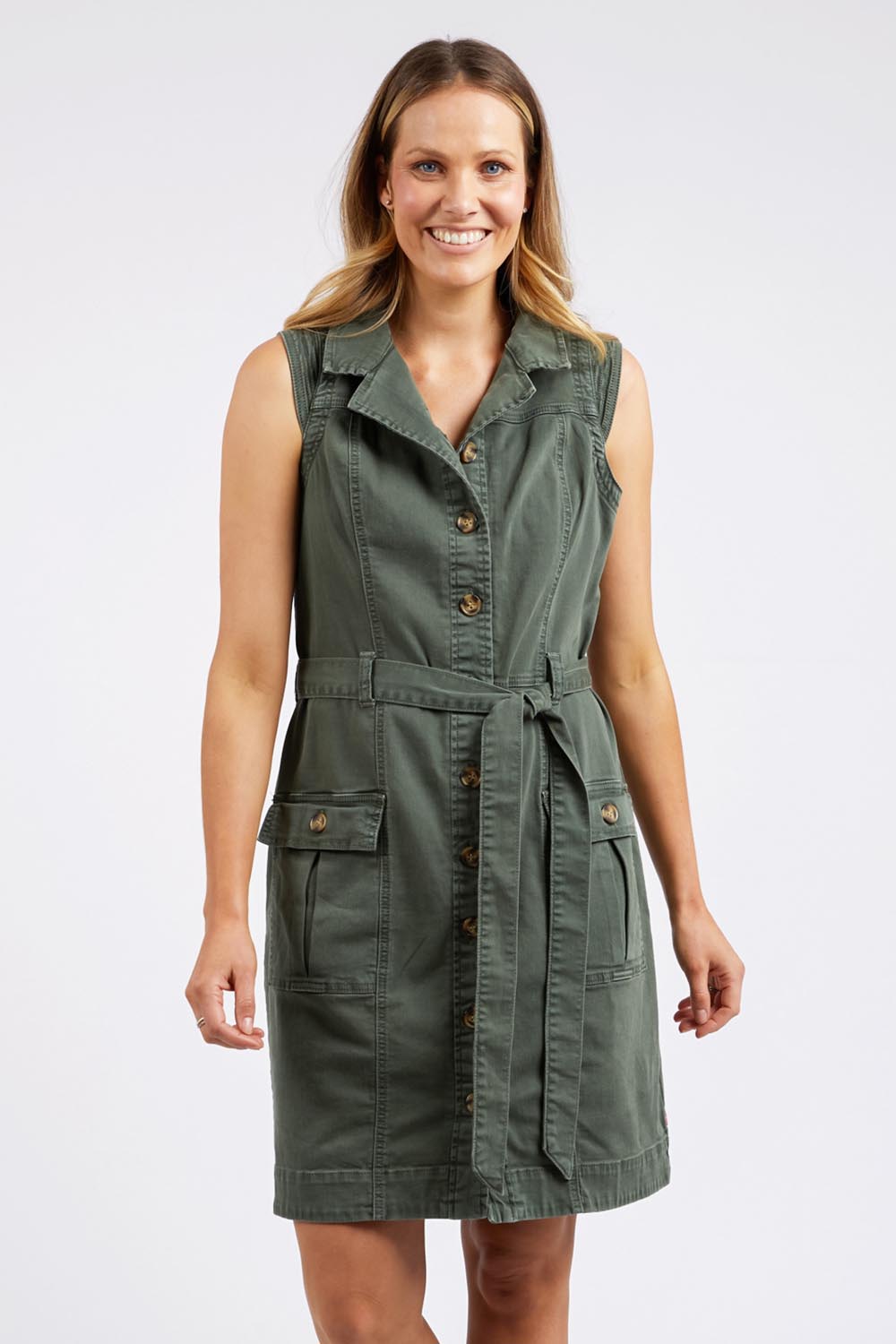 A model wearing the Marigold Denim Dress in colour Clover (Green), from the front, cropped image