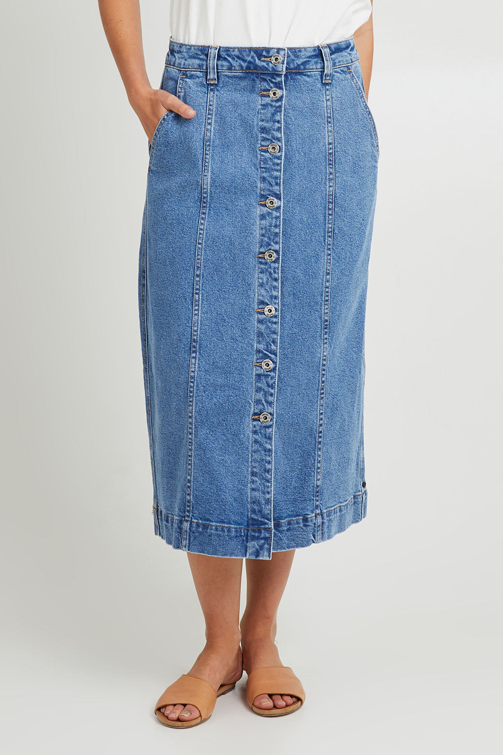 Model Madeline wearing size 10 of the Florence Button Through Skirt in colour Midblue (Blue), from the front, cropped image