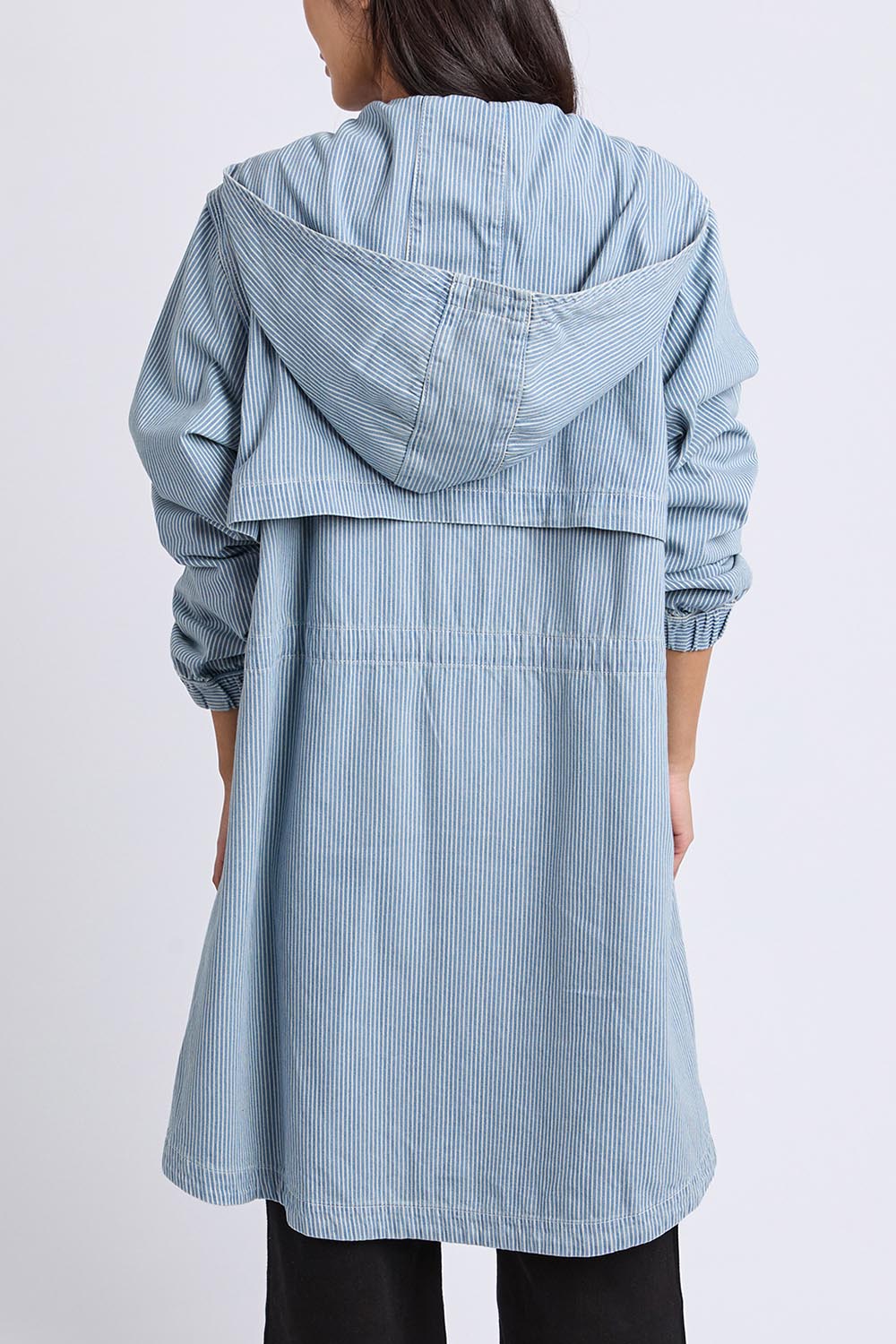 A model wearing the Bennett Denim Parker in colour Bluewhite (Blue), from the back