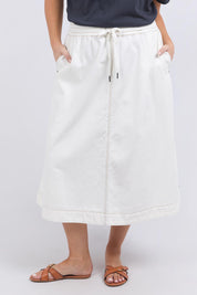 A model wearing the Fundamental Greta Denim Skirt in colour Vintgwhite (White), from the front, cropped image