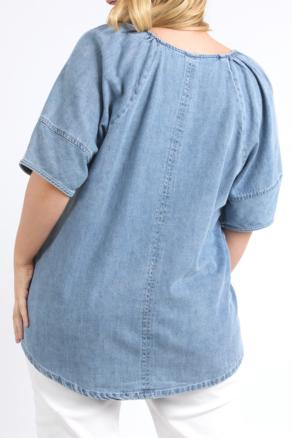 A model wearing the Brea Top in colour Bluewash (Blue), from the back