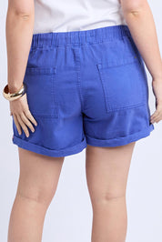A model wearing the Emma Relaxed Denim Short in colour Oceanblue (Blue), from the back