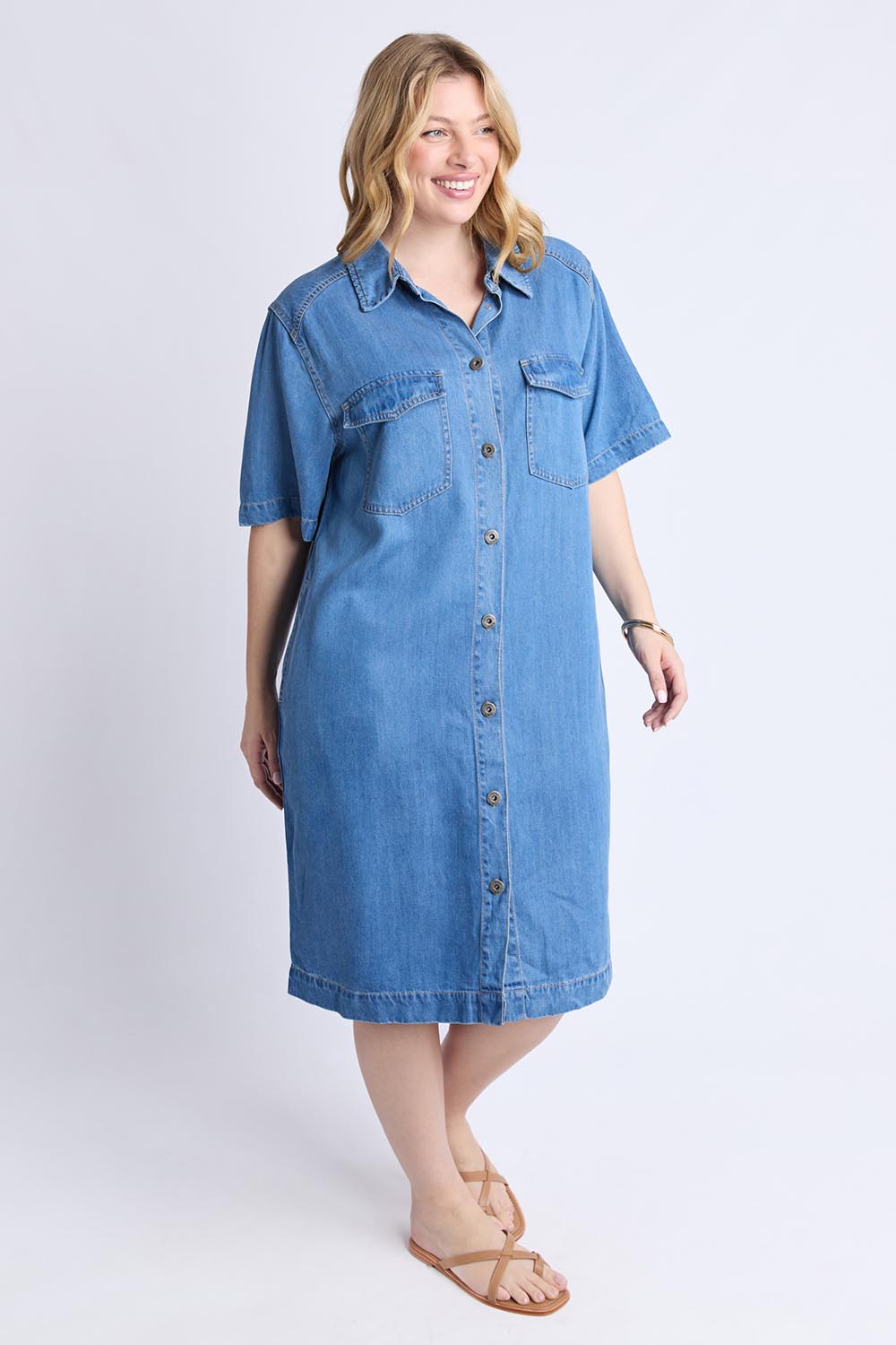 A model wearing the Cora Denim Lyocell Blend Dress in colour Misblue (Blue), from the front, showing the whole outfit