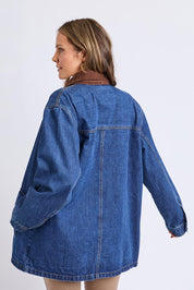 A model wearing the Lilian Denim Barn Jacket in colour Midblue (Blue), from the back