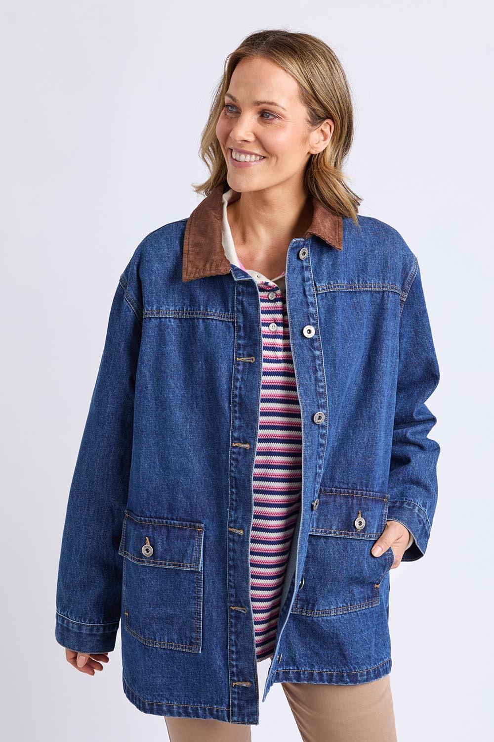 A model wearing the Lilian Denim Barn Jacket in colour Midblue (Blue), from the front, cropped image