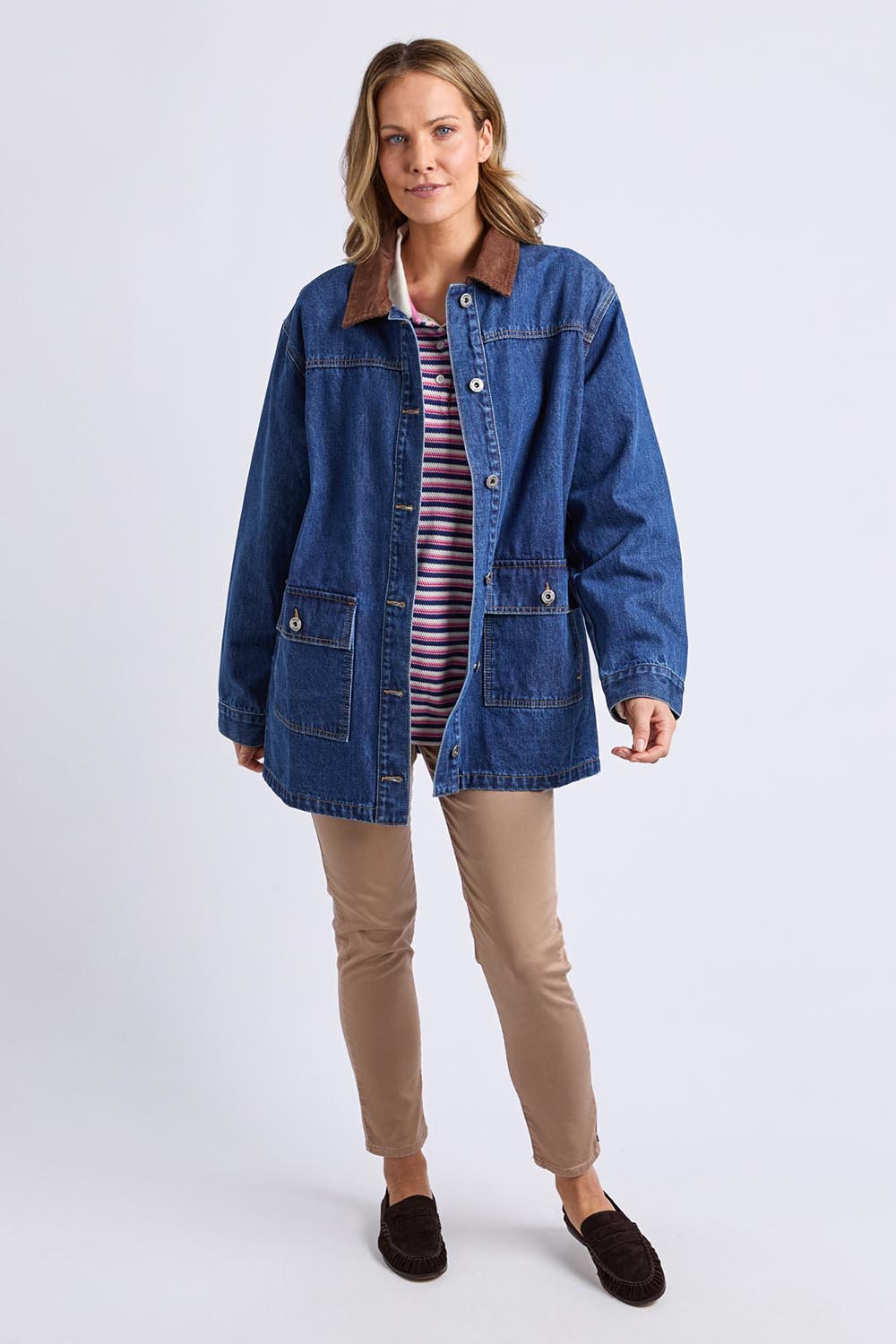 A model wearing the Lilian Denim Barn Jacket in colour Midblue (Blue), from the front, showing the whole outfit
