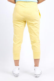 A model wearing the Fundamental Brunch Cotton Pant in colour Banana, from the back