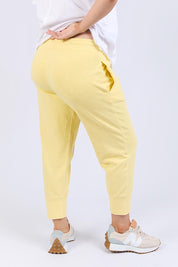 A model wearing the Fundamental Brunch Cotton Pant in colour Banana, from the back