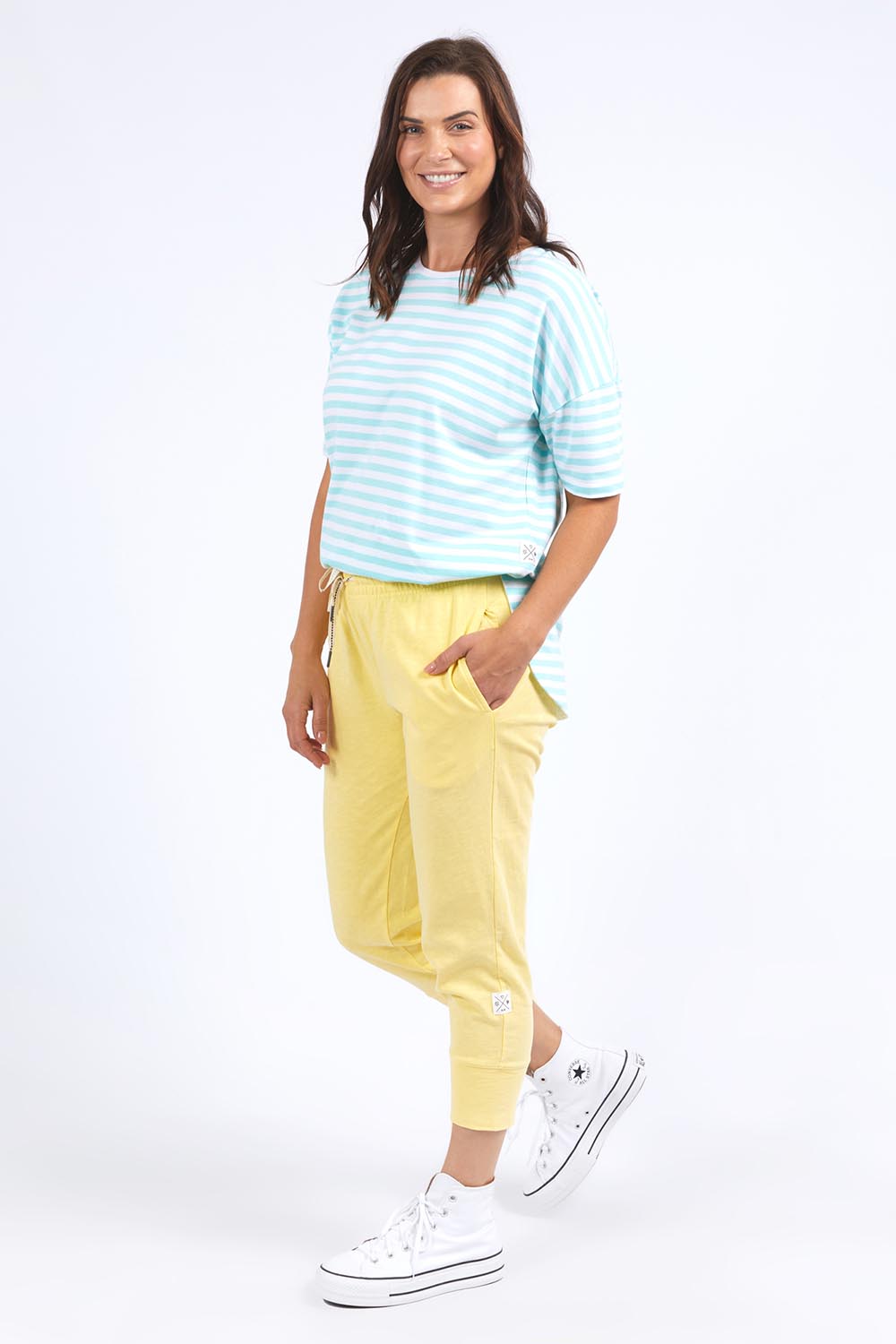 A model wearing the Fundamental Brunch Cotton Pant in colour Banana, from the front, showing the whole outfit
