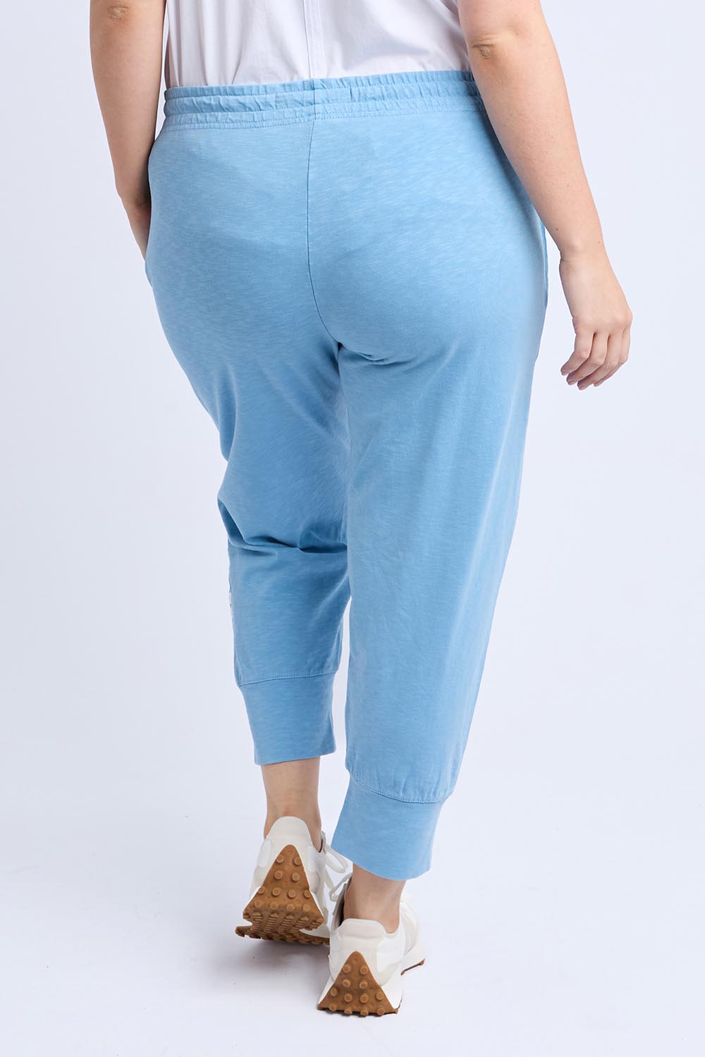 A model wearing the Fundamental Brunch Cotton Pant in colour Duskblue (Blue), from the back