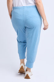 A model wearing the Fundamental Brunch Cotton Pant in colour Duskblue (Blue), from the back