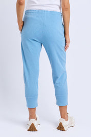 A model wearing the Fundamental Brunch Cotton Pant in colour Duskblue (Blue), from the back