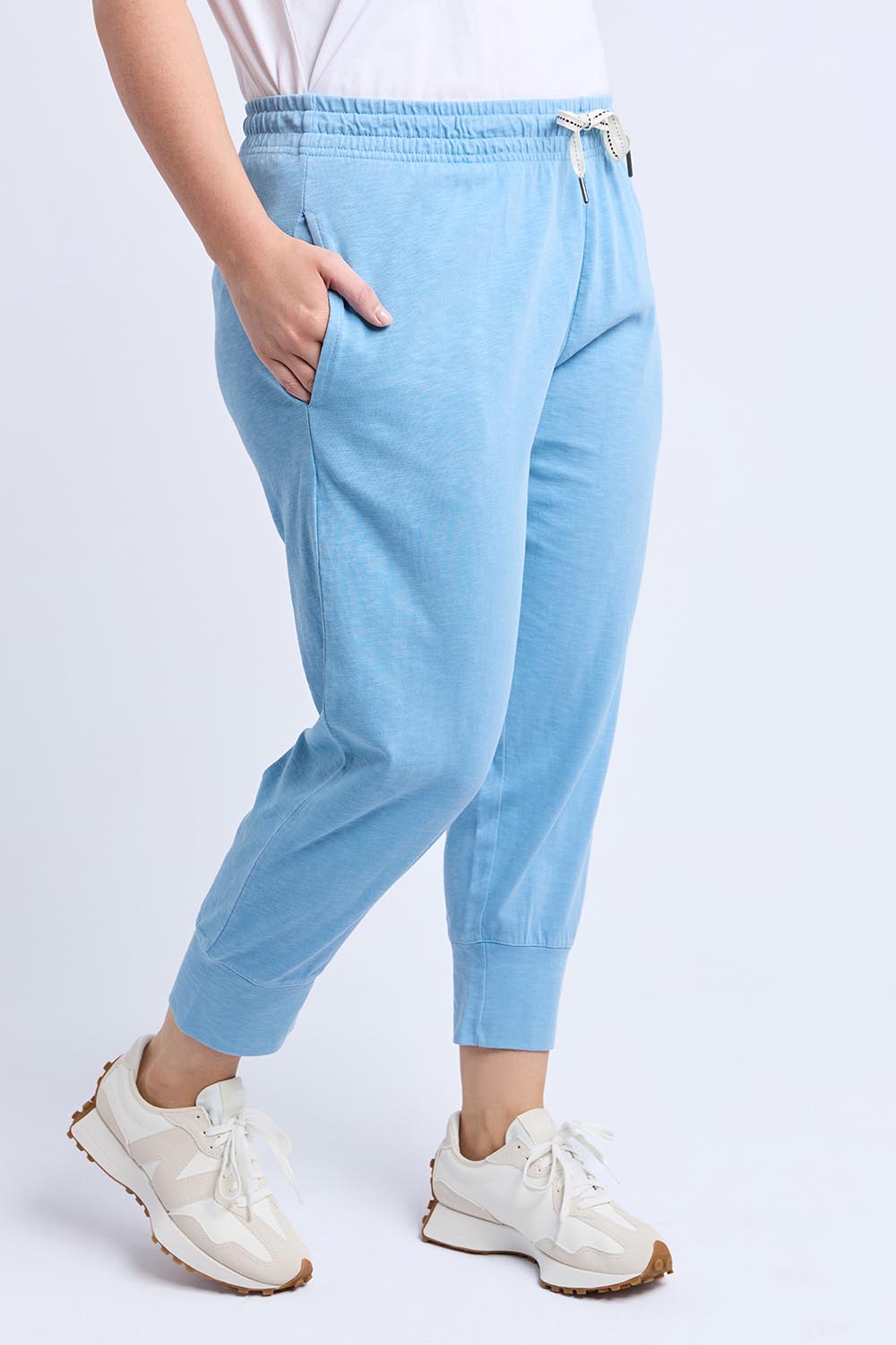A model wearing the Fundamental Brunch Cotton Pant in colour Duskblue (Blue), from the front, cropped image