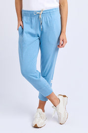 A model wearing the Fundamental Brunch Cotton Pant in colour Duskblue (Blue), from the front, cropped image